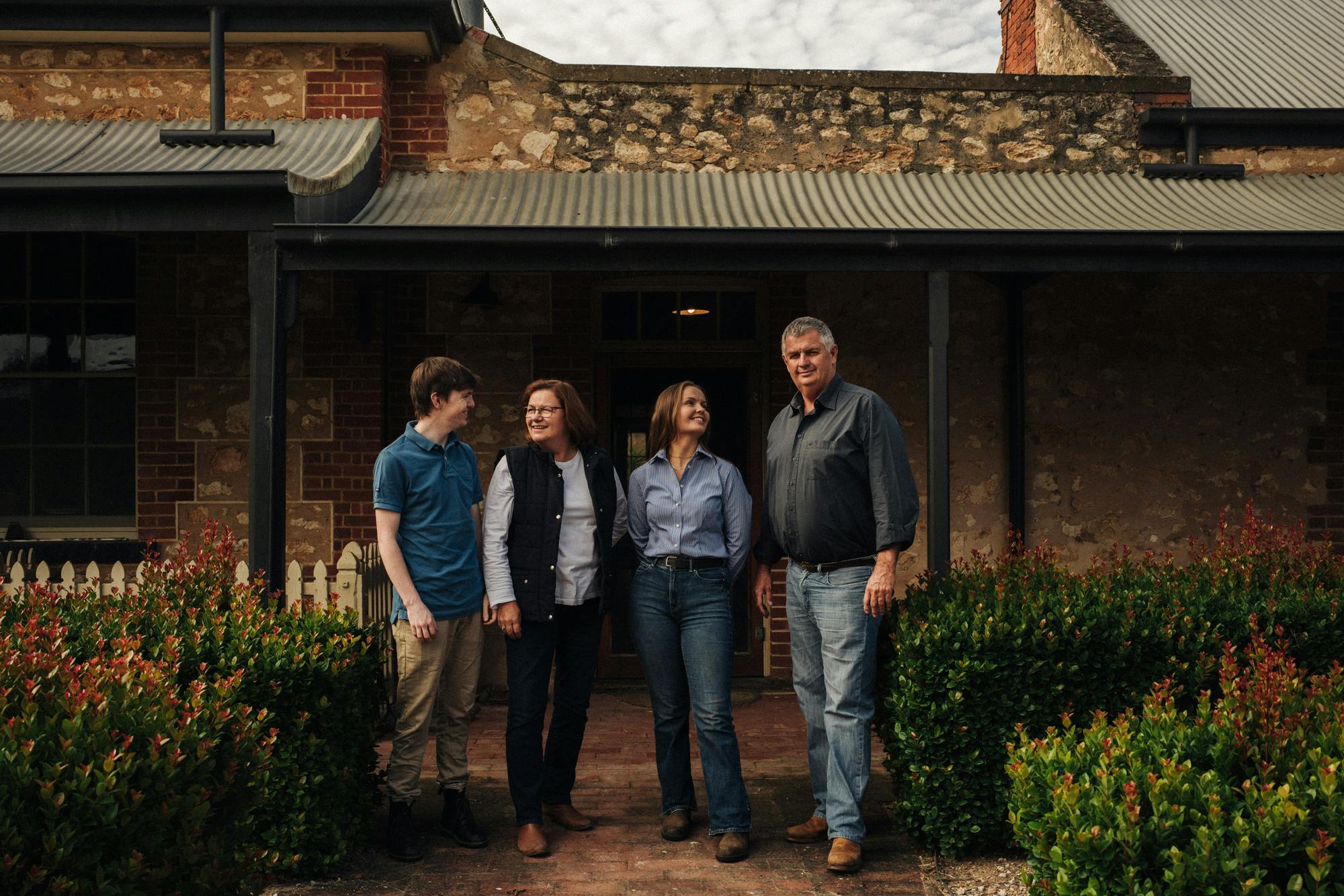 Family photo in front of homestead