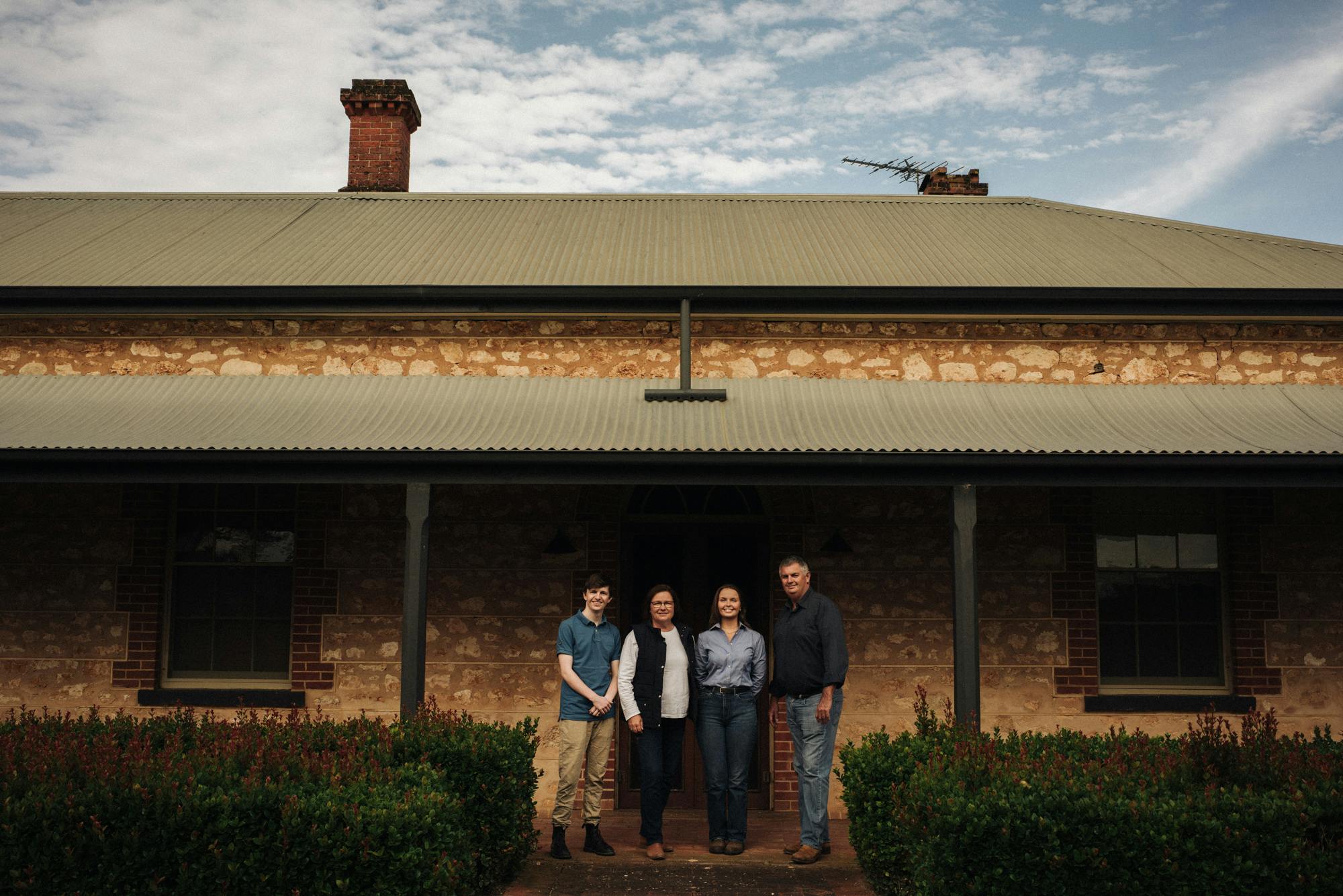 Family photo in front of house
